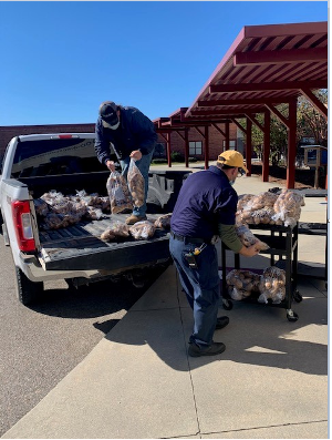 Unloading potatoes from truck bed