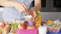 Hands adding garnish to bread